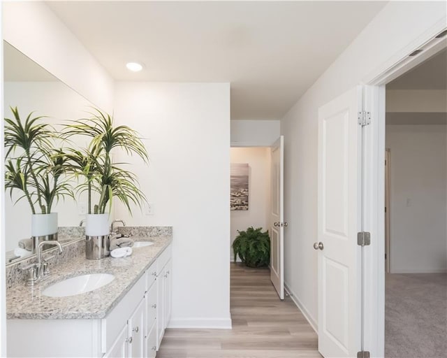 1577 Aiden Way Unit 39, Conyers, GA 30013 - full bathroom featuring double vanity, baseboards, and wood finished floors