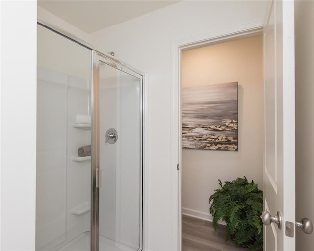 1577 Aiden Way Unit 39, Conyers, GA 30013 - bathroom featuring a stall shower, wood finished floors, and baseboards