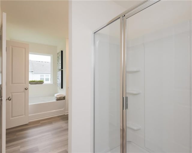 1577 Aiden Way Unit 39, Conyers, GA 30013 - full bathroom featuring a shower stall, wood finished floors, and a garden tub