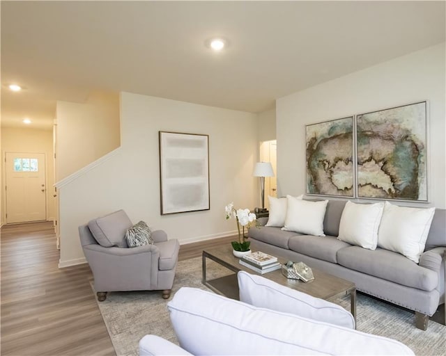 1577 Aiden Way Unit 39, Conyers, GA 30013 - living room featuring wood finished floors, baseboards, recessed lighting, and stairs
