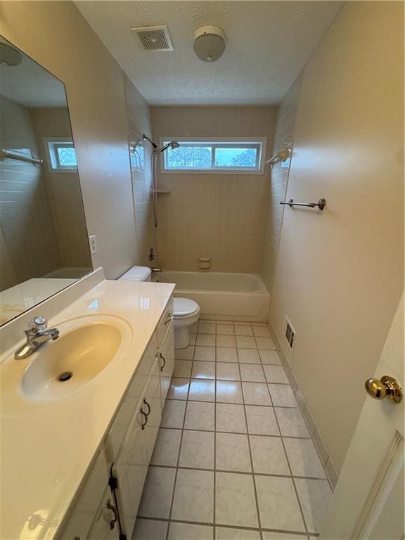 full bathroom featuring tile patterned floors, vanity, toilet, and a healthy amount of sunlight