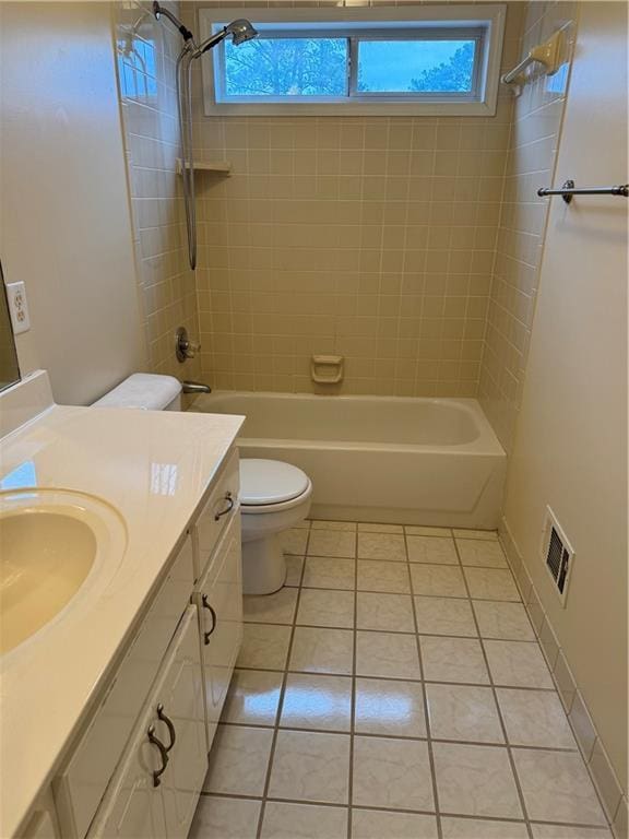 full bathroom featuring toilet, vanity, tile patterned flooring, and tiled shower / bath combo