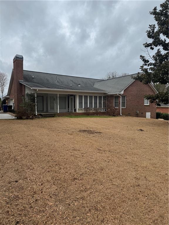 back of house with a lawn