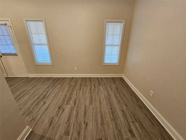 empty room featuring dark wood-type flooring