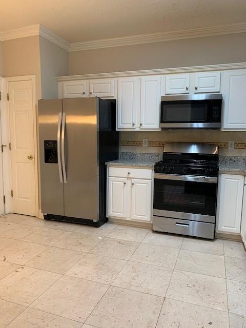 kitchen with appliances with stainless steel finishes and white cabinets