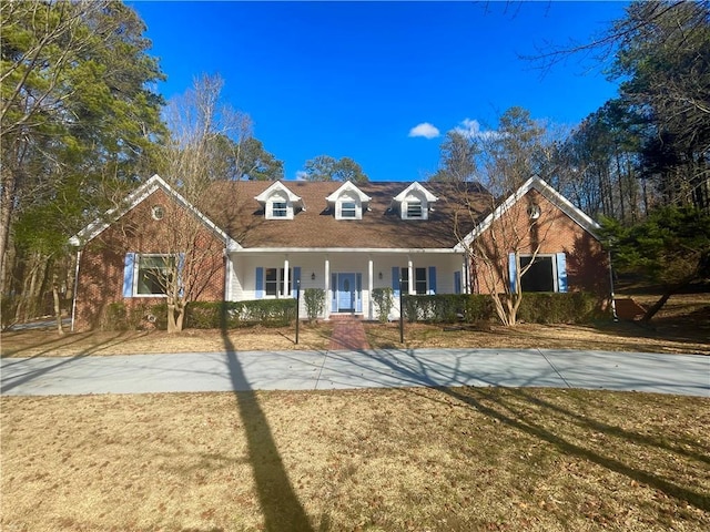 new england style home featuring a front yard