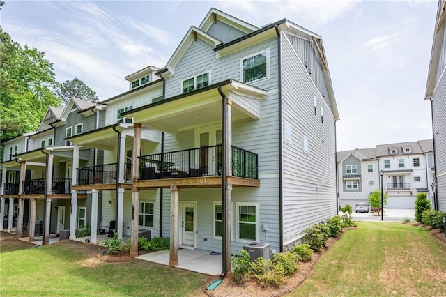 3518 Mount Blue Ave, Tucker, GA 30084 - rear view of property featuring a lawn, board and batten siding, a patio area, and a balcony