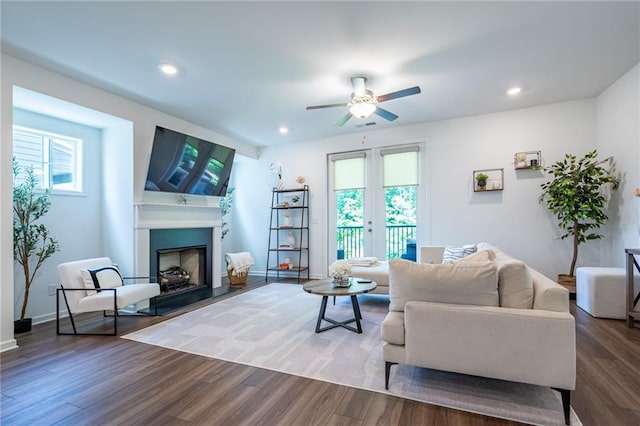 3518 Mount Blue Ave, Tucker, GA 30084 - living area with plenty of natural light, a ceiling fan, a fireplace with raised hearth, wood finished floors, and recessed lighting