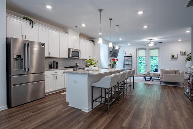 3518 Mount Blue Ave, Tucker, GA 30084 - kitchen featuring stainless steel appliances, open floor plan, dark wood finished floors, a ceiling fan, and white cabinets