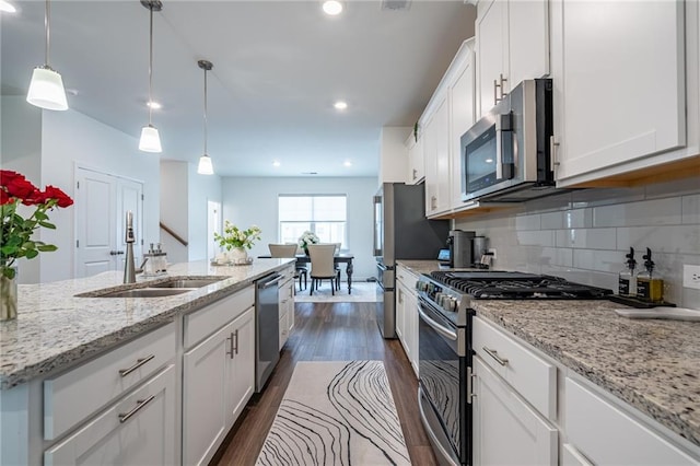 3518 Mount Blue Ave, Tucker, GA 30084 - kitchen with stainless steel appliances, a sink, white cabinetry, dark wood-style floors, and tasteful backsplash