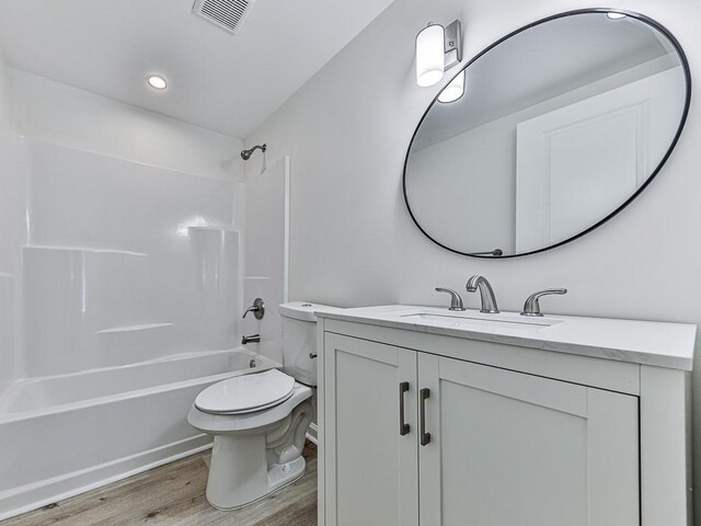 full bathroom featuring shower / tub combination, toilet, vanity, and hardwood / wood-style flooring