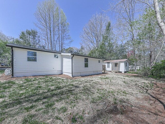 back of property with a storage shed