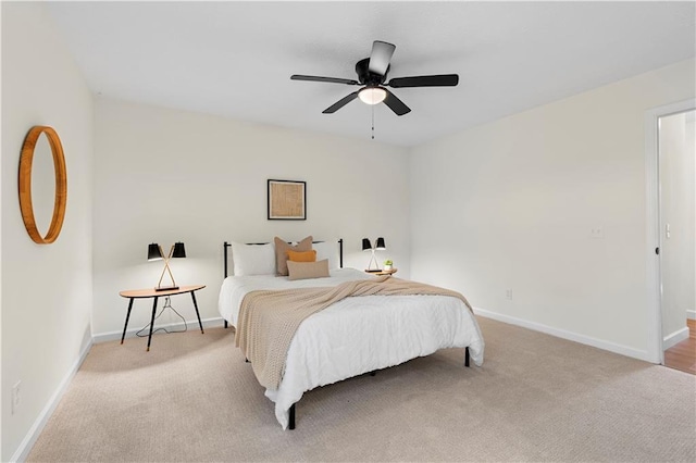 bedroom with light carpet and ceiling fan