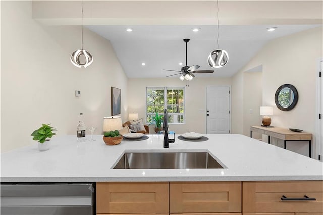 kitchen featuring hanging light fixtures, lofted ceiling, sink, and dishwashing machine