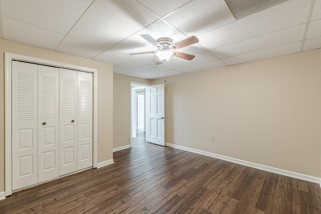 7928 S Giles Rd, Douglasville, GA 30135 - unfurnished bedroom with a paneled ceiling, baseboards, dark wood-style floors, a closet, and a ceiling fan
