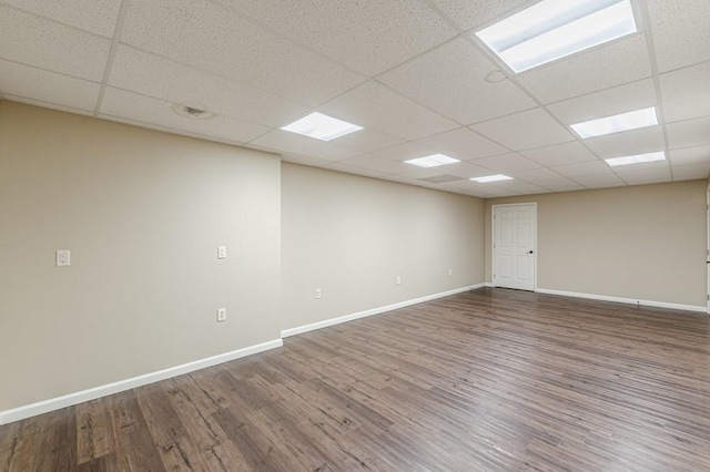 7928 S Giles Rd, Douglasville, GA 30135 - empty room with wood finished floors, a paneled ceiling, and baseboards