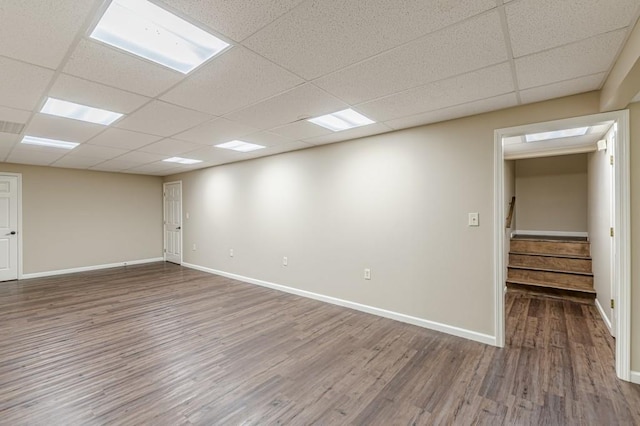 7928 S Giles Rd, Douglasville, GA 30135 - spare room with wood finished floors, baseboards, a paneled ceiling, and stairway