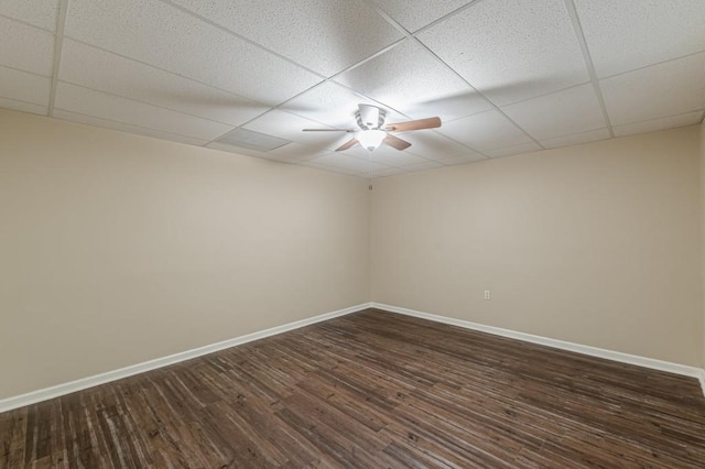 7928 S Giles Rd, Douglasville, GA 30135 - empty room featuring a drop ceiling, baseboards, dark wood-style flooring, and a ceiling fan