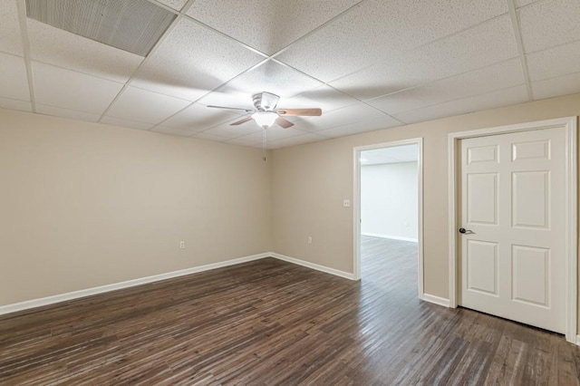 7928 S Giles Rd, Douglasville, GA 30135 - empty room with ceiling fan, baseboards, a paneled ceiling, and dark wood-type flooring