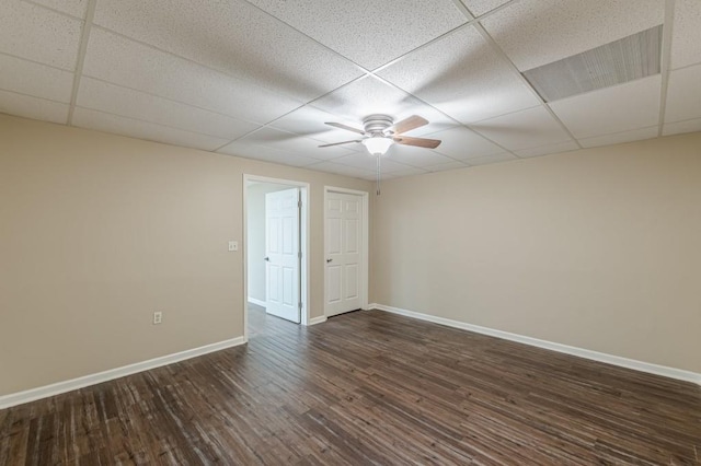 7928 S Giles Rd, Douglasville, GA 30135 - empty room featuring a drop ceiling, ceiling fan, dark wood finished floors, and baseboards