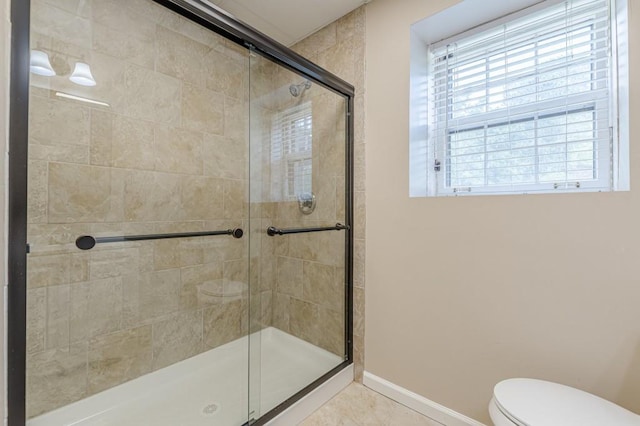 7928 S Giles Rd, Douglasville, GA 30135 - full bathroom featuring tiled shower, baseboards, toilet, and tile patterned flooring