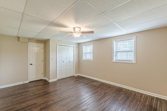 7928 S Giles Rd, Douglasville, GA 30135 - unfurnished bedroom with baseboards, dark wood-style floors, a closet, and a drop ceiling