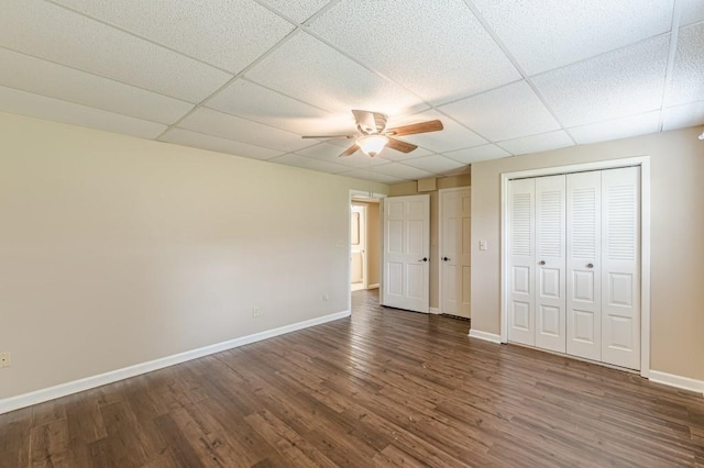 7928 S Giles Rd, Douglasville, GA 30135 - unfurnished bedroom featuring baseboards, wood finished floors, a drop ceiling, and ceiling fan
