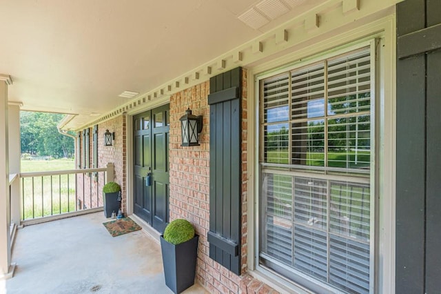 7928 S Giles Rd, Douglasville, GA 30135 - doorway to property featuring covered porch, brick siding, and board and batten siding