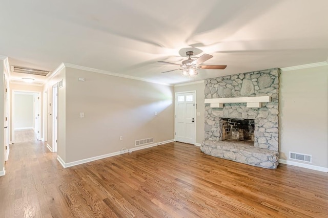 7928 S Giles Rd, Douglasville, GA 30135 - unfurnished living room with ceiling fan, ornamental molding, wood finished floors, baseboards, and a stone fireplace