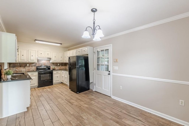 7928 S Giles Rd, Douglasville, GA 30135 - kitchen with black appliances, dark countertops, under cabinet range hood, a sink, and a chandelier