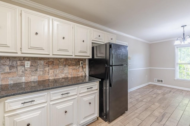 7928 S Giles Rd, Douglasville, GA 30135 - kitchen with freestanding refrigerator, baseboards, backsplash, white cabinets, and ornamental molding