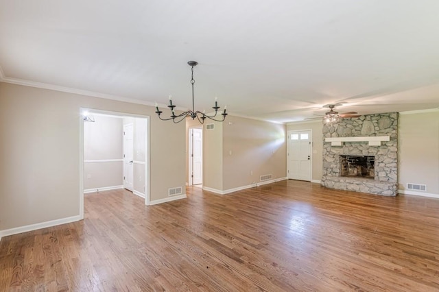 7928 S Giles Rd, Douglasville, GA 30135 - unfurnished living room featuring a chandelier, a ceiling fan, ornamental molding, wood finished floors, and a fireplace