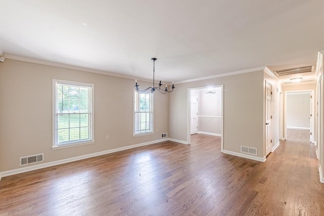 7928 S Giles Rd, Douglasville, GA 30135 - spare room with crown molding, wood finished floors, baseboards, and a chandelier