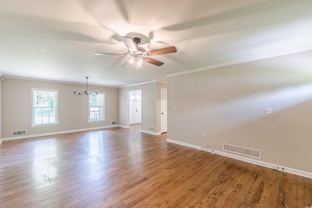 7928 S Giles Rd, Douglasville, GA 30135 - empty room featuring crown molding, ceiling fan, a chandelier, baseboards, and wood finished floors