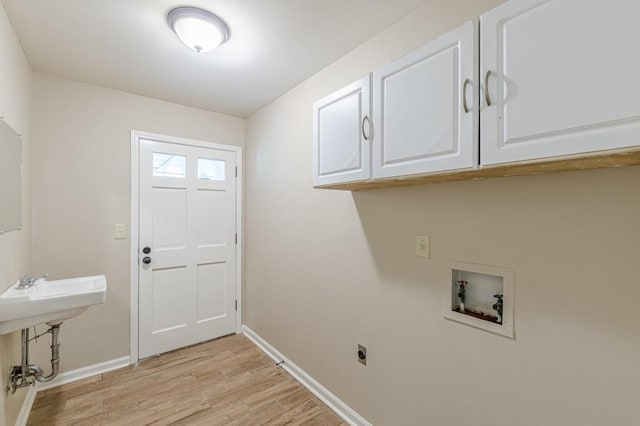 7928 S Giles Rd, Douglasville, GA 30135 - laundry room with cabinet space, hookup for an electric dryer, hookup for a washing machine, baseboards, and light wood finished floors
