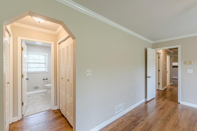 7928 S Giles Rd, Douglasville, GA 30135 - hall with crown molding, wood finished floors, arched walkways, and baseboards