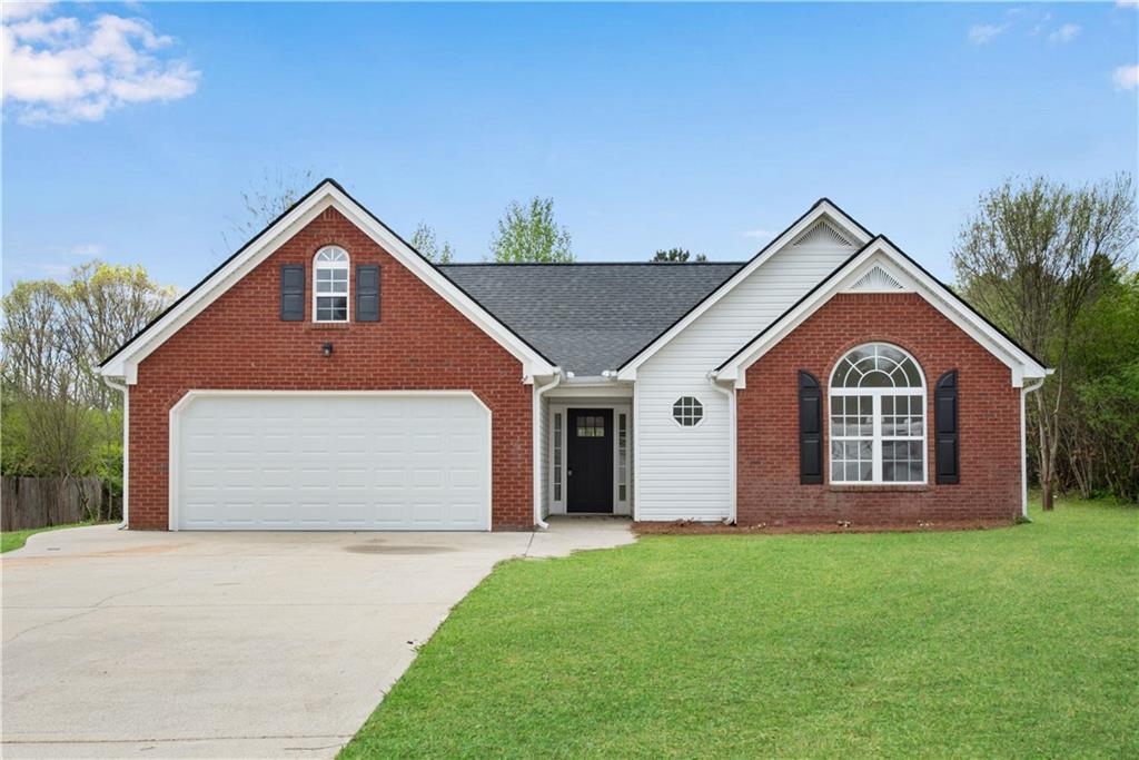 111 Shenandoah Ct, Hiram, GA 30141 - ranch-style house with brick siding, concrete driveway, and a front lawn