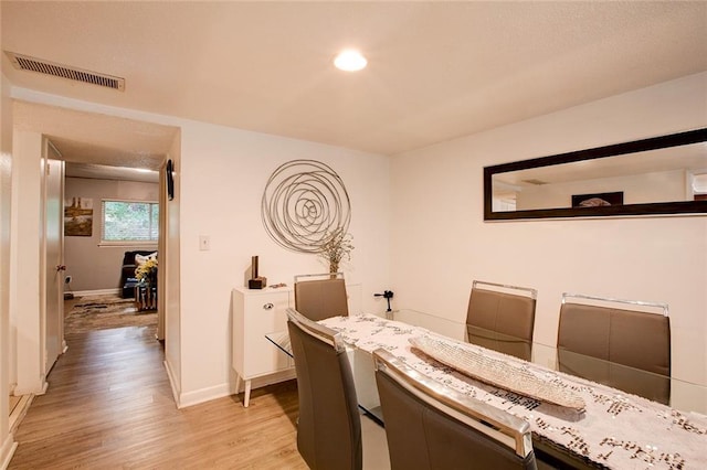 dining space with light hardwood / wood-style floors