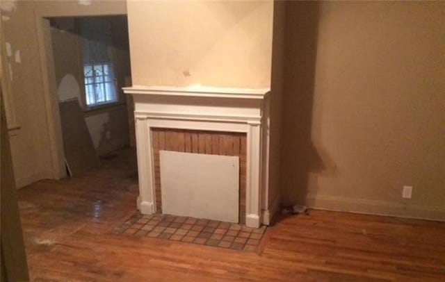 interior details featuring wood finished floors and baseboards