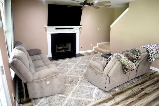 living room featuring wood-type flooring and ceiling fan