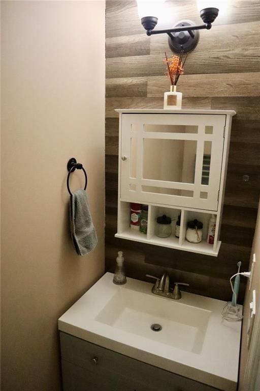 bathroom with vanity and wooden walls