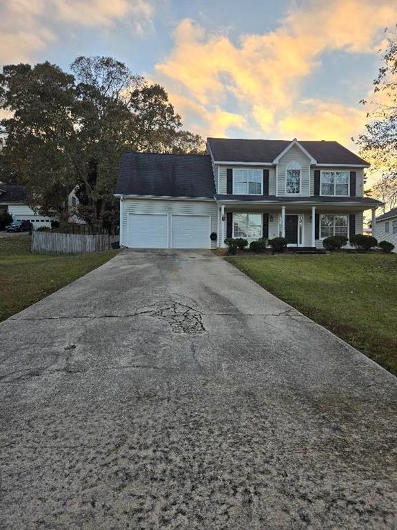 view of front of home with a lawn and a garage