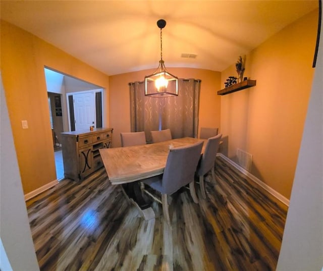 dining space featuring dark hardwood / wood-style floors and lofted ceiling