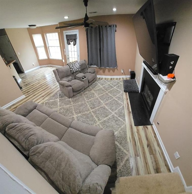 living room with ceiling fan and wood-type flooring