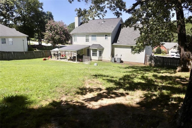 back of property with a yard, a patio, and central air condition unit