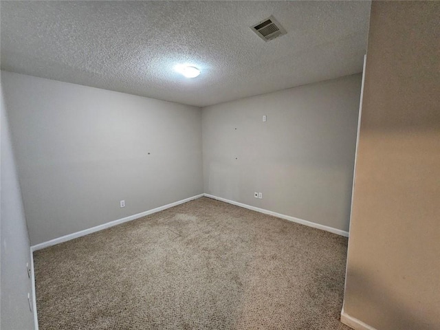 spare room with carpet and a textured ceiling