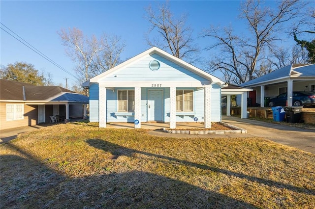 bungalow featuring a carport, driveway, and a porch