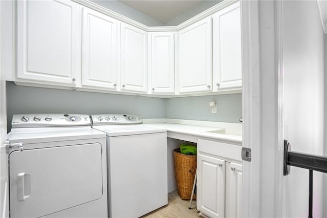 laundry area with cabinets, independent washer and dryer, and light tile patterned floors