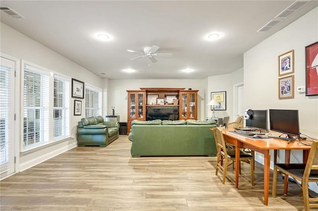 living room featuring ceiling fan and light hardwood / wood-style flooring