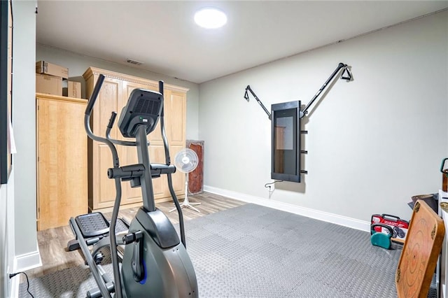 exercise room featuring hardwood / wood-style floors